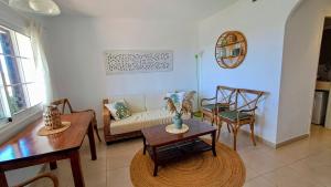 a living room with a couch and a table and chairs at Mar & Calma in Son Bou