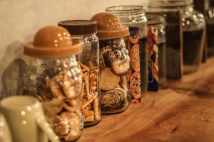 a group of glass jars filled with nuts and cookies at Rock Wood Hotel in Sungai Petani