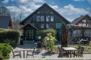 a large building with tables and chairs in front of it at Bordmann` Scheune in Kolonie