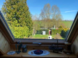 a window in a house with a view of a yard at Ferienhaus Deubel Escobar in Kappeln