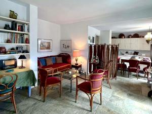 a living room with a couch and a table and chairs at Pepromeno Boutique in Agios Dimitrios