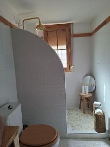 a bathroom with a toilet and a mirror at Amira home suite in Sant Pere de Ribes
