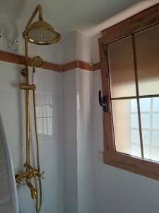 a shower in a bathroom with a window at Amira home suite in Sant Pere de Ribes