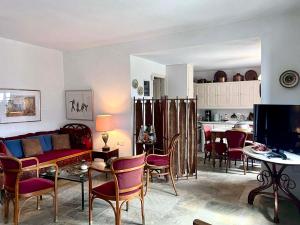 a living room with a couch and a table with chairs at Pepromeno Boutique in Agios Dimitrios +32 photos