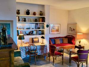 a living room with a couch and a table and chairs at Pepromeno Boutique in Agios Dimitrios