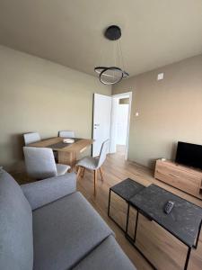 a living room with a couch and a table at SeaLaVir Apartments in Vir