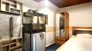 a kitchen with a refrigerator and a bed in a room at BLACKCOMs Erika in Goslar +4 photos