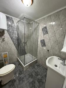 a bathroom with a shower and a toilet and a sink at SeaLaVir Apartments in Vir +10 photos