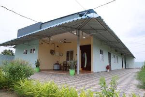 a house with awning and a patio at Premium House or Office In Amaravati in Sūriapālem