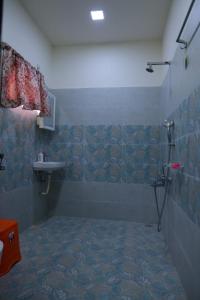 a bathroom with a shower and a sink at Premium House or Office In Amaravati in Sūriapālem +18 photos