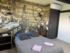a bedroom with a bed with two towels on it at dépendance de la Métairie in Bignan