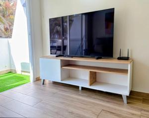 a white entertainment center with a flat screen tv at Sanmarcos 2 in Adeje