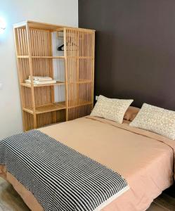 a bed in a room with a book shelf at Sanmarcos 2 in Adeje +8 photos