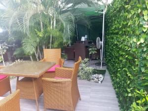 a patio with a table and chairs and plants at Vintage classic suits in Lagos