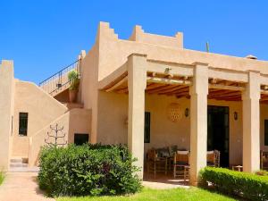 a house with a patio and a dining room at Palais Nova in Marrakesh +60 photos