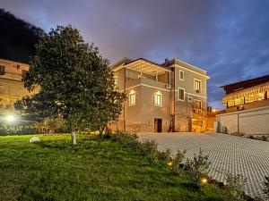 a large house with a tree in front of it at Dimora Alfinito in Salerno