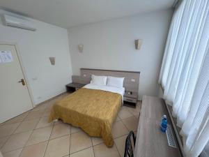 a bedroom with a bed and a bench in it at La Conchiglia in Sperlonga