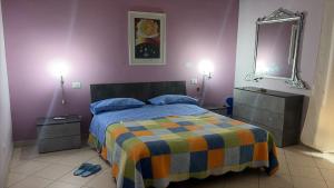 a bedroom with a bed with a colorful blanket at B&B arpaia in Arpaia