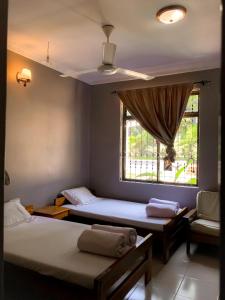 a room with two beds and a window at Kiusa Badget Hotel in Moshi