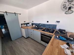 a kitchen with a sink and a stove at Eco Hideaway in Anoyira