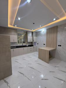 a kitchen with a marble floor and a wooden counter at درة القيم in Taif +35 photos