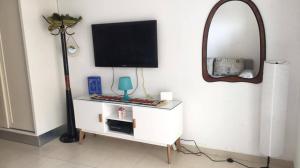 a living room with a tv and a mirror at Studio with private beach Folla Residence in Akouda