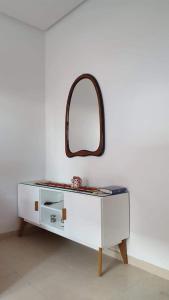 a white dresser with a mirror on a wall at Studio with private beach Folla Residence in Akouda +6 photos
