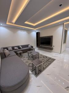 a living room with a couch and a tv at درة القيم in Taif
