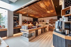 a kitchen with a counter in a restaurant at Scandic Ruoholahti in Helsinki