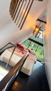 a room with two beds and a window at Chalé estrela de ouro in Alexânia