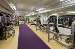 a gym with tread machines and a purple carpet at Scandic Ruoholahti in Helsinki