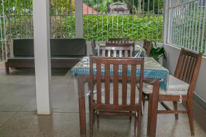 a table and chairs sitting on a porch at Kiusa Badget Hotel in Moshi