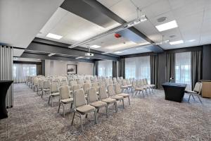 a conference room with a row of chairs and a podium at Hotel Kossak in Krakow