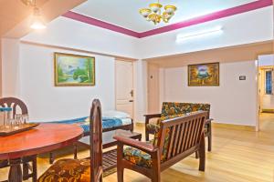 a living room with a table and chairs and a dining room at Hotel Mount View in Kodaikānāl