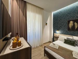 a bedroom with a bed and a table with candles on it at Dimora Alfinito in Salerno