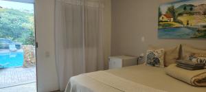 a bedroom with a bed and a sliding glass door at Chalés da Cris in Fortim +182 photos