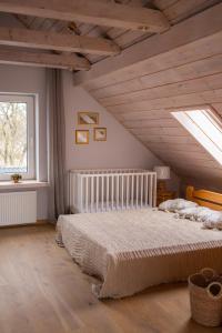 a bedroom with a large bed in a attic at Dorupes House in Liepāja