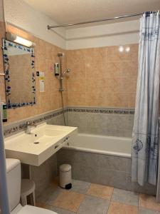 a bathroom with a sink and a tub and a toilet at sol appart hotel in Banyuls-sur-Mer +40 photos