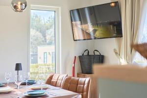 a dining room with a table and a large window at Ostseecamp Salt & Sea in Scharbeutz