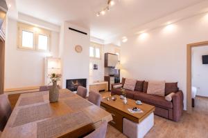 a living room with a couch and a table at AeroHill Suites Near Athens Airport By SEM in Artemida