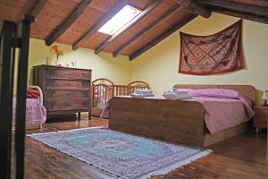 a bedroom with a bed and a dresser and a rug at Casa Vacanza La Papuzza Mare e Etna in Mascali +34 photos