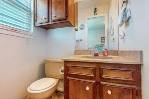 a bathroom with a toilet and a sink at Leeward Cove B4 in Padre Island +19 photos