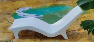 a pair of white slides in a pool of water at Chalés da Cris in Fortim