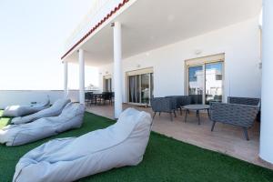 a living room with bean bags on the grass at AeroHill Suites Near Athens Airport By SEM in Artemida