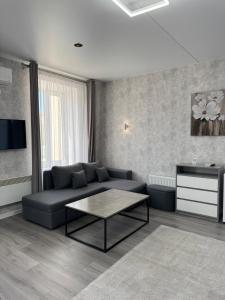 a living room with a couch and a coffee table at Готель Elisavetgrad in Kropyvnytskyi