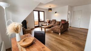 a living room with a couch and a table at Wolke 7 – PEAK Andreasberg in Sankt Andreasberg