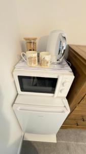 a white table with two cups on top of it at Suite 3 En-suite Room with Double Bed in Edinburgh