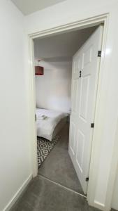 a room with a closet with a bed and a door at Suite 3 En-suite Room with Double Bed in Edinburgh