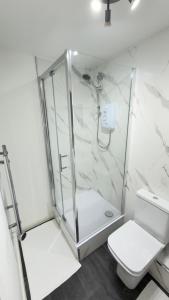 a bathroom with a shower and a toilet at Suite 3 En-suite Room with Double Bed in Edinburgh