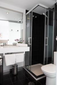 a bathroom with a shower and a toilet and a sink at Rolix hc Hostal in Fuente-Álamo +54 photos